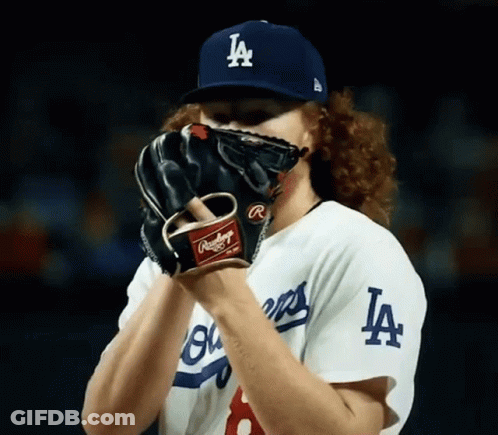 Baseball Player Covering Face With LA Hat And Glove GIF
