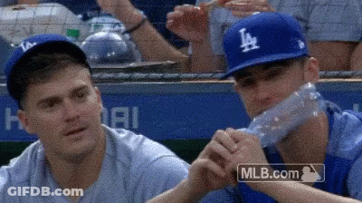 Baseball Player Drinking Water While Another Watches GIF