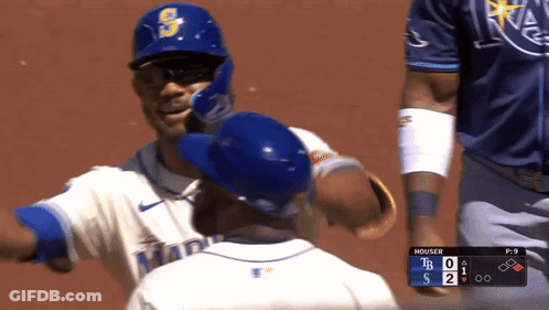 Baseball Player Hugging Teammate In Blue Helmet GIF