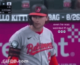 Baseball Player In Baltimore Jersey In Front Of Pink Sign GIF