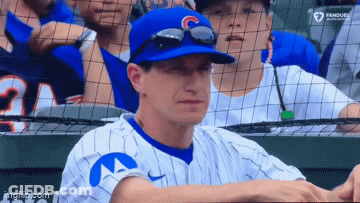 Baseball Player In Blue Hat With Letter C Sitting In Dugout GIF