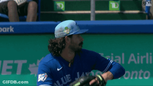 Baseball Player In Blue Jays Jersey Holding Glove GIF