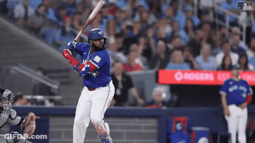 Baseball Player In Blue Jays Uniform Swinging Bat GIF