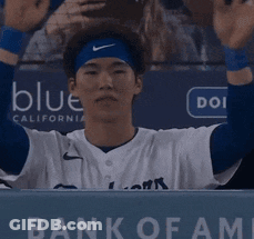 Baseball Player In Dugout With Bank Of Fame Sign GIF