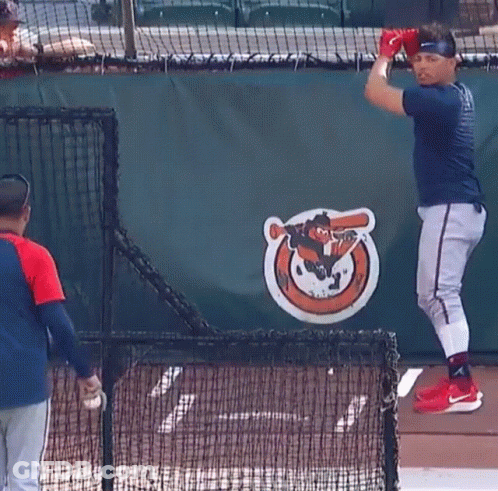 Baseball Player In Front Of Orioles Logo GIF