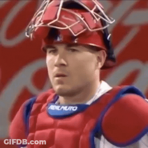 Baseball Player In Helmet And Chest Protector Looking At Camera GIF