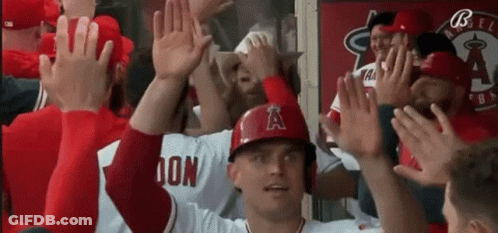 Baseball Player In Helmet With A High Five GIF