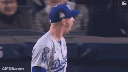 Baseball Player In LA Hat In Front Of Yankees.com Sign GIF