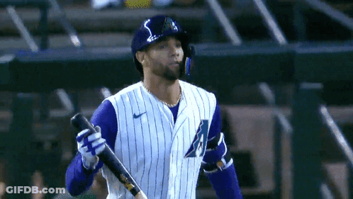 Baseball Player In Purple And White Striped Uniform Holding Bat GIF