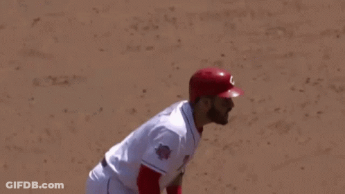 Baseball Player In Red Helmet Gloves Swinging Bat GIF
