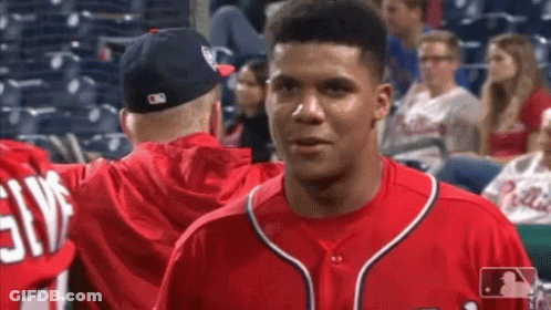 Baseball Player In Red Jersey Talking To Another GIF