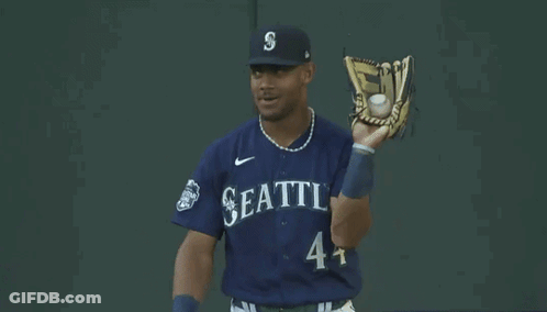 Baseball Player In Seattle Uniform Holding Glove GIF
