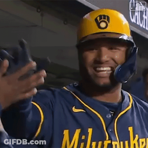 Baseball Player In Yellow Helmet And Blue Jersey Smiling And Waving GIF