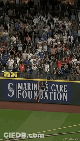 Baseball Player Jumping Over Fence GIF
