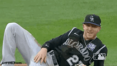 Baseball Player Laying On Field With Legs Crossed GIF