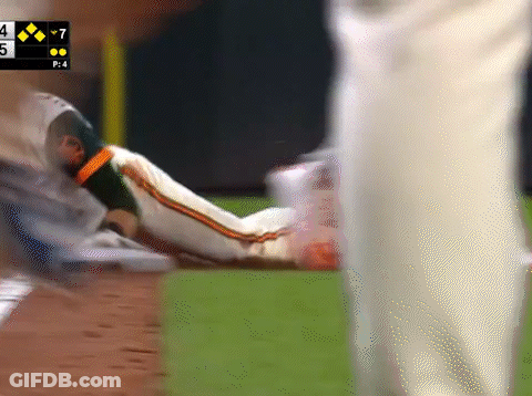 Baseball Player Laying On Ground With Scoreboard Saying 7 GIF