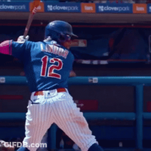 Baseball Player Number 12 Swings Bat GIF
