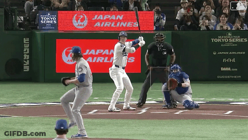 Baseball Player Ready To Swing In Front Of Japan Airlines Ad GIF
