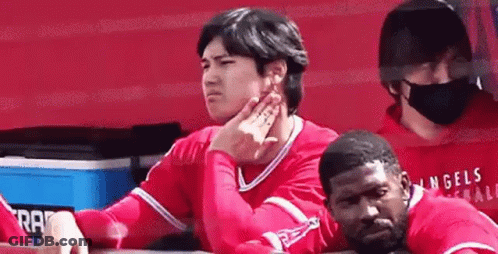 Baseball Player Sitting In Dugout With Hand On Chin GIF