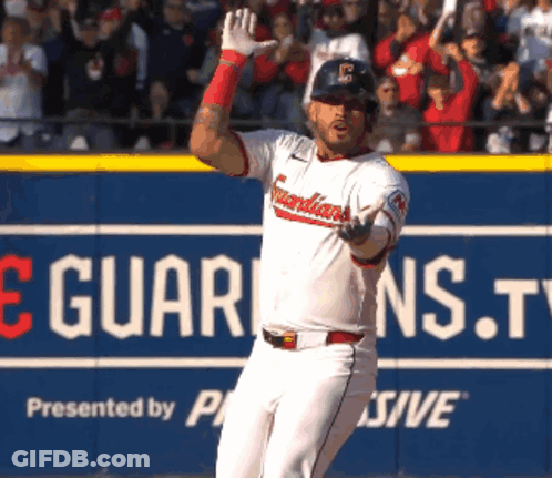Baseball Player Standing In Front Of Guardians.tv Sign GIF