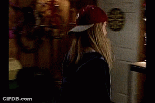 Baseball Player Standing Next To Woman In Chair GIF