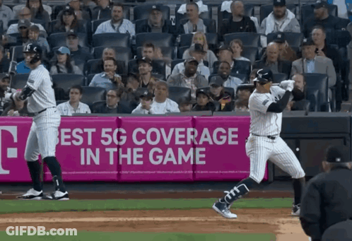 Baseball Player Swinging At Ball In Front Of 5G Ad GIF