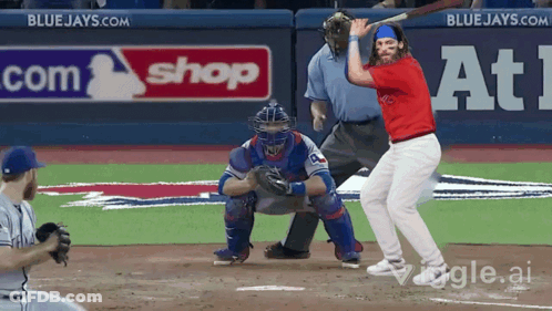 Baseball Player Swinging At Ball In Front Of Blue Jays Sign GIF