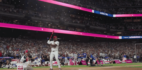 Baseball Player Swinging At Magenta Ball Sign GIF