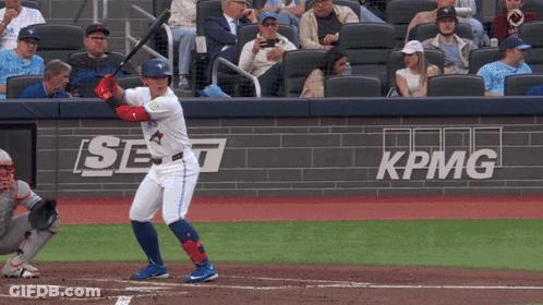 Baseball Player Swinging At Pitch In Front Of KPMG Banner GIF