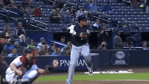 Baseball Player Swinging At Pitch In Front Of PNB Bank Banner GIF