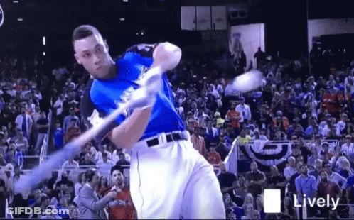 Baseball Player Swinging Bat At Ball Before Crowd GIF
