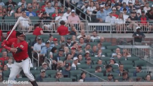 Baseball Player Swinging Bat At Ball In Crowd GIF