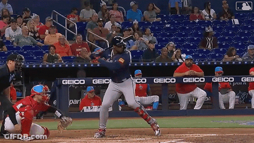 Baseball Player Swinging Bat In Front Of Geico Banner GIF