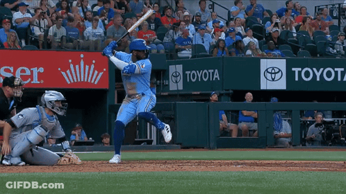 Baseball Player Swinging Bat In Front Of Toyota Ad GIF