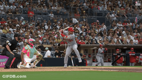 Baseball Player Swinging Bat With Catcher Watching GIF