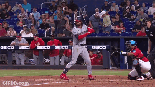 Baseball Player Swinging Bat With Geico Banner GIF