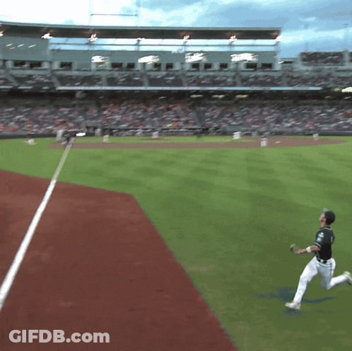 Baseball Player Throwing Ball In Front Of Crowd At Stadium GIF