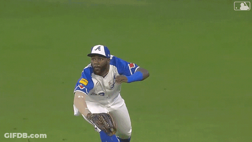 Baseball Player Wearing Number 23 Lying On Grass GIF