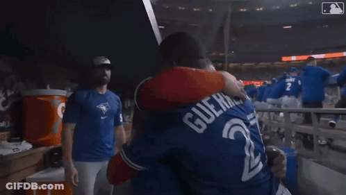 Baseball Players Hugging In Stadium GIF