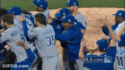 Baseball Players Hugging On Field With MLB.com Logo GIF