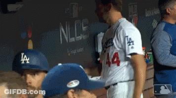 Baseball Players In Dugout One Wearing LA Hat GIF