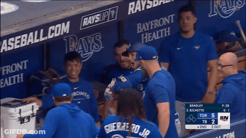 Baseball Players In Dugout With Bayfront Health And Rays Ads GIF