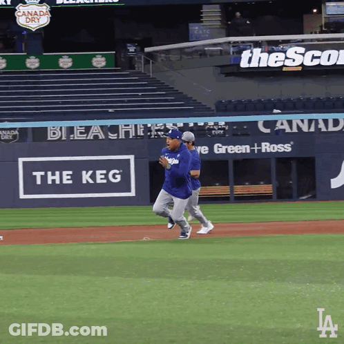 Baseball Players Running On Field With Keg Sign GIF