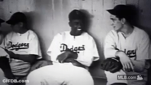 Baseball Players Sitting In Dugout Talking GIF