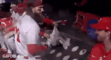 Baseball Players Sitting In Dugout GIF