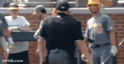 Baseball Players Standing In Front Of Brick Wall GIF