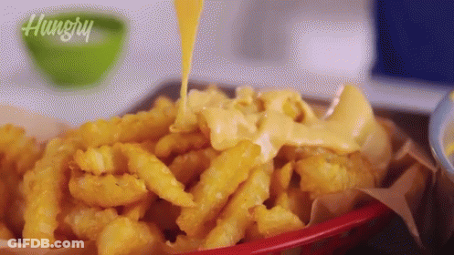 Basket Of French Fries With Cheese Being Poured GIF