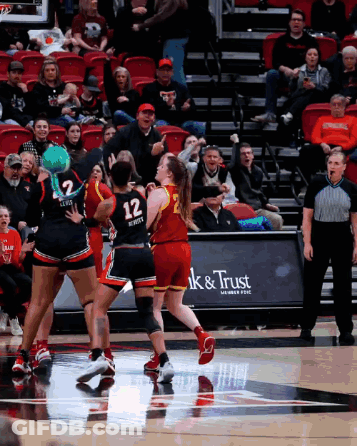 Basketball Game In Front Of Ak & Trust Sign GIF