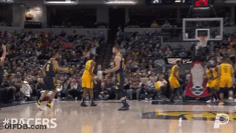 Basketball Game In Front Of Crowd With Pacers On Floor GIF
