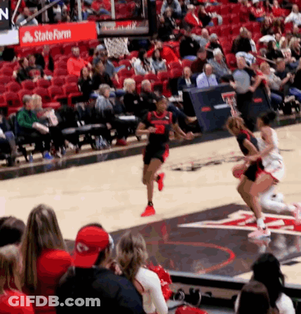 Basketball Game In Front Of Crowd With State Farm Sign GIF